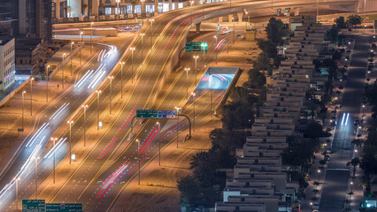 Traffic on the road in Jumeirah Lakes Towers district aerial night timelapse.