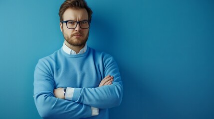 A beautiful man with glasses, standing against a blue background