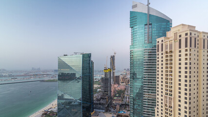 Waterfront overview Jumeirah Beach Residence JBR skyline aerial day to night timelapse with yacht and boats