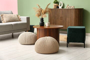 Interior of modern living room with coffee table and poufs