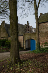 Outer wall entrance of historic residences Begijnhoff in City Lier Belgium. Protected buildings are peaceful place to live, pretty landmark popular with tourists. Culture and history in Belgian life - 781545210