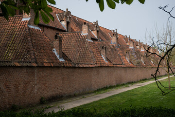 Outer wall of historic residences Begijnhoff in City Lier Belgium. Protected buildings are peaceful place to live and pretty landmark popular with tourists. Culture and history in Belgian life - 781545222
