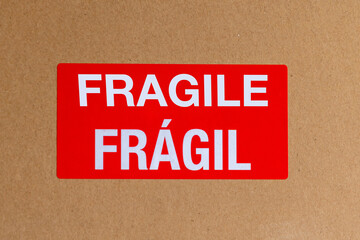Red sticker with fragile word on cardboard transport box