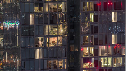 Night view of exterior apartment tower timelapse. High rise skyscraper with blinking lights in windows