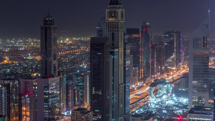 Skyline of the buildings of Sheikh Zayed Road and DIFC aerial night to day timelapse in Dubai, UAE. - obrazy, fototapety, plakaty