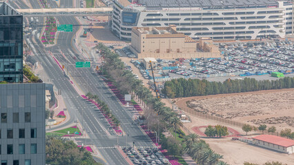 Skyline view of intersection traffic on Al Saada street near DIFC night timelapse in Dubai, UAE.