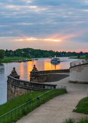 Sunset on the Elbe River in the famous city of Dresden. Tourist, pleasure boats slowly sail along...
