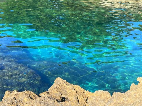 Beautiful sea turquoise blue water and coastal rocks.