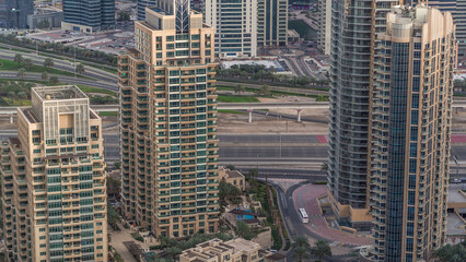 Fototapeta premium Dubai Marina skyscrapers and jumeirah lake towers view from the top aerial timelapse in the United Arab Emirates.