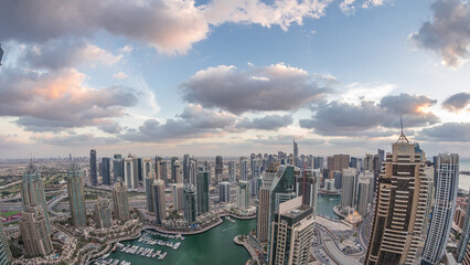 Dubai Marina skyscrapers and jumeirah lake towers view from the top aerial day to night timelapse...