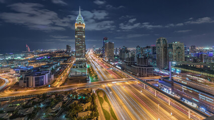 Skyline internet city with crossing Sheikh Zayed Road aerial night timelapse