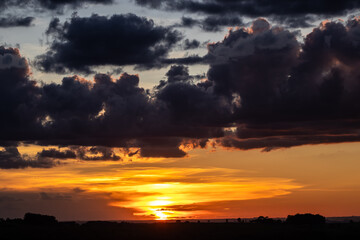 Sunset in the sky with clouds,  Awesome epic landscape. Amazing vibrant colors im Brazil