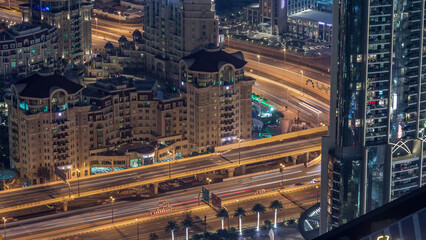 Aerial view of highway interchange in Dubai downtown evening timelapse.