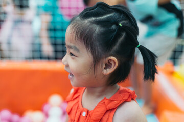 portrait of a 6 years old Chinese girl playing happily