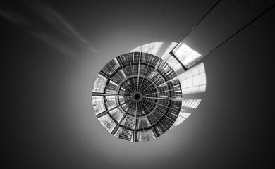 A round glass ceiling with sunlight in a black and white photo style in Germany