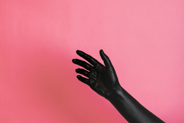 Gesticulation of black painted elegant woman's hand on her skin. High Fashion art concept