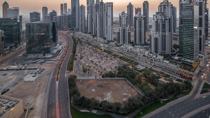 Fototapeta na wymiar Modern residential and office complex with many towers aerial day to night timelapse at Business Bay, Dubai, UAE.