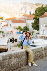 Happy woman exploring city streets. Lifestyle, travel, tourism, active life.