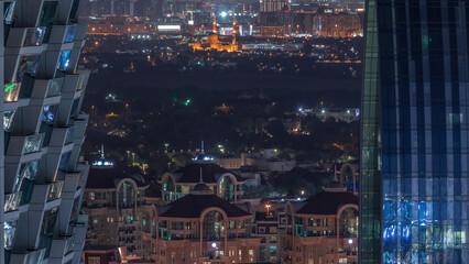 Fototapeta na wymiar Aerial view to neighborhood Deira and Dubai creek with typical old and modern buildings night timelapse.