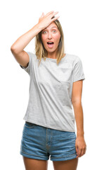 Fototapeta premium Young beautiful woman over isolated background surprised with hand on head for mistake, remember error. Forgot, bad memory concept.