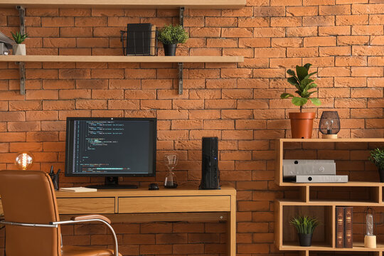 Interior of modern office with programmer's workplace and shelves