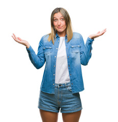 Young beautiful woman over isolated background clueless and confused expression with arms and hands...