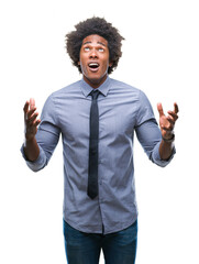 Fototapeta premium Afro american business man over isolated background crazy and mad shouting and yelling with aggressive expression and arms raised. Frustration concept.