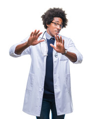 Afro american doctor man over isolated background afraid and terrified with fear expression stop gesture with hands, shouting in shock. Panic concept.