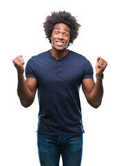 Fototapeta premium Afro american man over isolated background celebrating surprised and amazed for success with arms raised and open eyes. Winner concept.