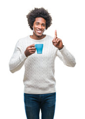 Afro american man drinking cup of coffee over isolated background surprised with an idea or question pointing finger with happy face, number one