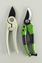 Different secateurs on grey background
