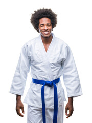 Afro american man wearing karate kimono over isolated background winking looking at the camera with...