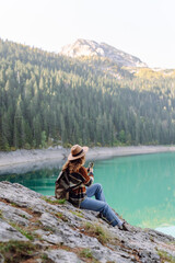 Young woman tourist uses a smartphone on the nature. Lifestyle, travel, tourism, active life.