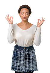 Young african american woman over isolated background relax and smiling with eyes closed doing meditation gesture with fingers. Yoga concept.