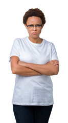 Obraz premium Beautiful young african american woman wearing glasses over isolated background skeptic and nervous, disapproving expression on face with crossed arms. Negative person.