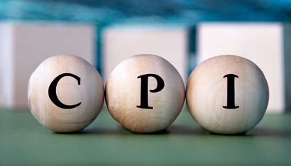 CPI - acronym on wooden balls on the background of wooden large cubes
