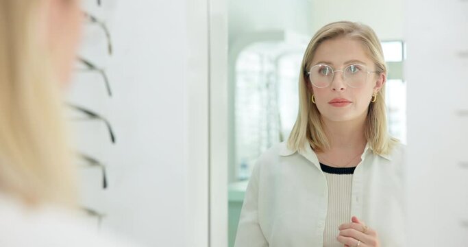 Store, woman and fitting with glasses for eyes, business and mirror, shopping and serious. Eyewear, shop and female people, vision and product, frame and healthcare, customer and look in reflection