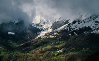 View of the snow-capped Pyrenees and village in south-west France
