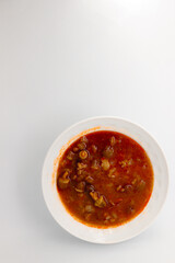 Okra soup with meat, white isolated background.