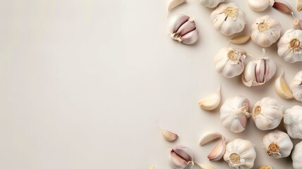 Fototapeta na wymiar Fresh garlic bulbs scattered on a light grey surface.