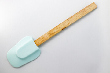 Wooden tablespoon with silicone head. White background. - obrazy, fototapety, plakaty
