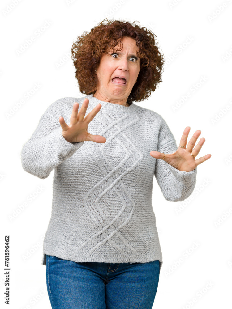 Sticker beautiful middle ager senior woman wearing winter sweater over isolated background afraid and terrif