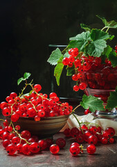 Red currants in glass vase. A red currants on the table with garnishes on top