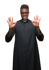 Young african american priest man over isolated background showing and pointing up with fingers number ten while smiling confident and happy.