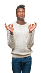 Young african american man over isolated background relax and smiling with eyes closed doing meditation gesture with fingers. Yoga concept.