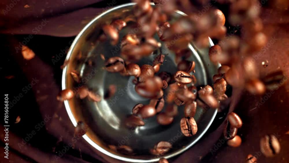 Wall mural super slow motion coffee beans in a working grinder. high quality fullhd footage