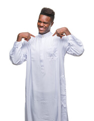 Young arabic african man wearing traditional djellaba over isolated background looking confident...