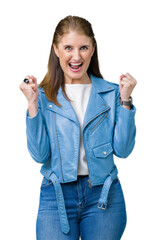 Beautiful middle age mature woman wearing fashion leather jacket over isolated background celebrating surprised and amazed for success with arms raised and open eyes. Winner concept.