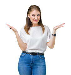 Middle age mature beautiful woman over isolated background clueless and confused expression with...