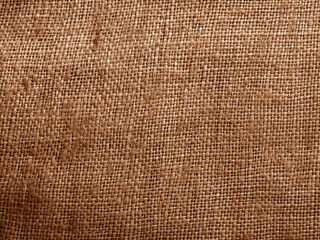 Soft focus close-up revealing the textured background of brown sackcloth